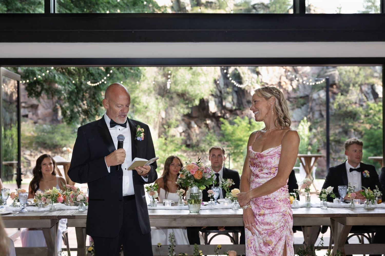 Wedding reception tables set elegantly indoors with natural light streaming through windows.