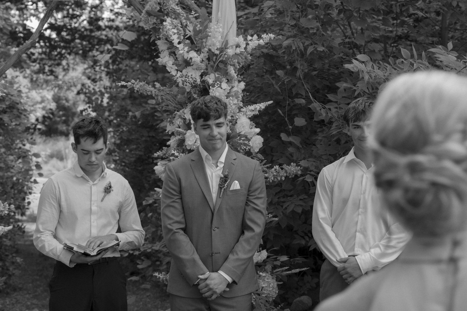 Black and white photo of wedding ceremony emotions during vows.