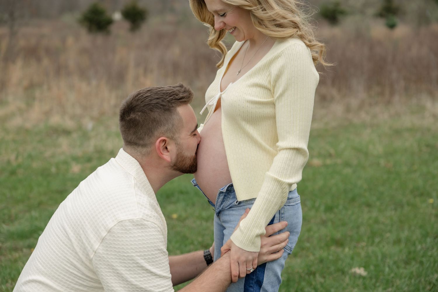 Intimate maternity photo sequence showing tender moments in an outdoor field.
