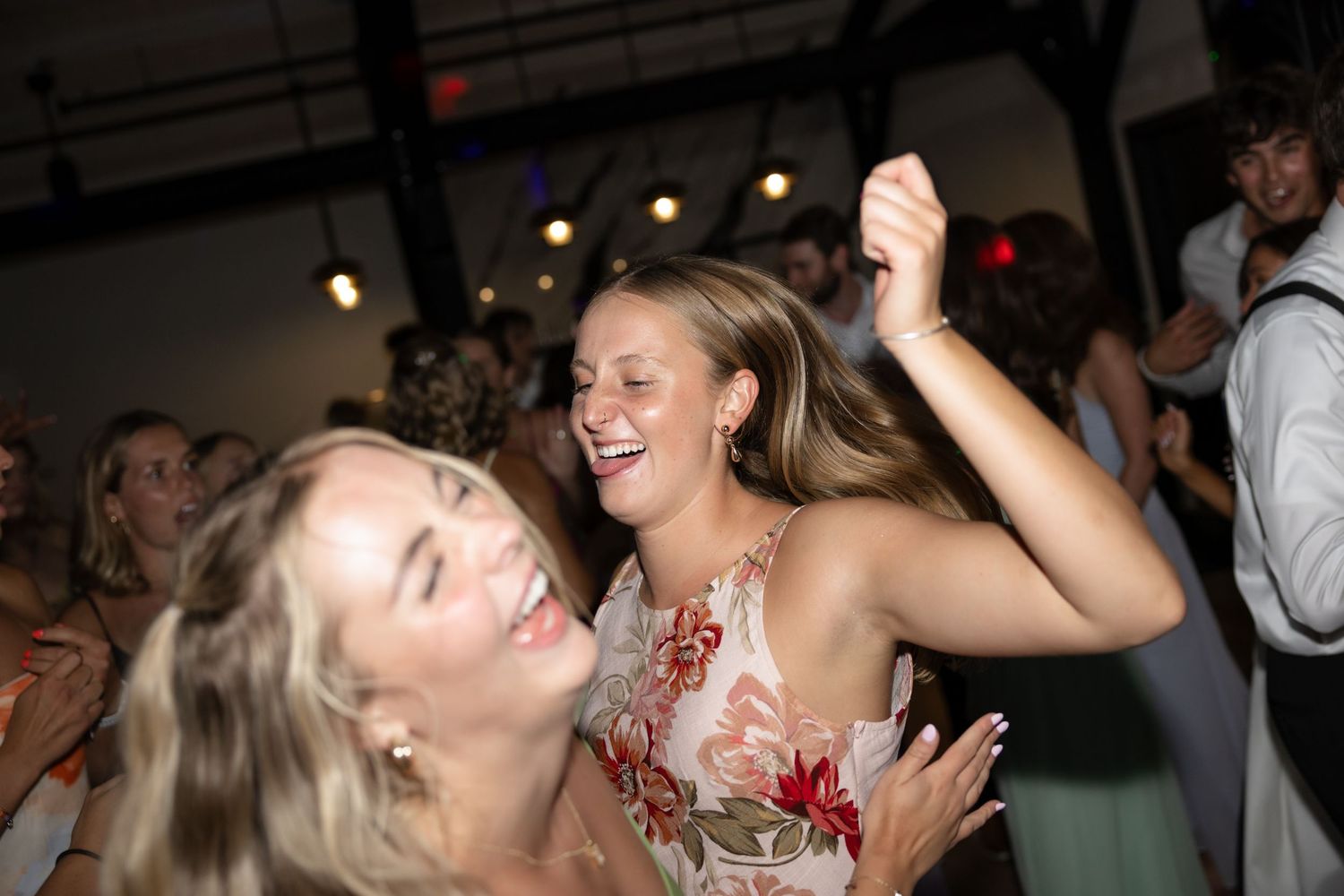 Energetic dancers enjoying themselves at a wedding party.