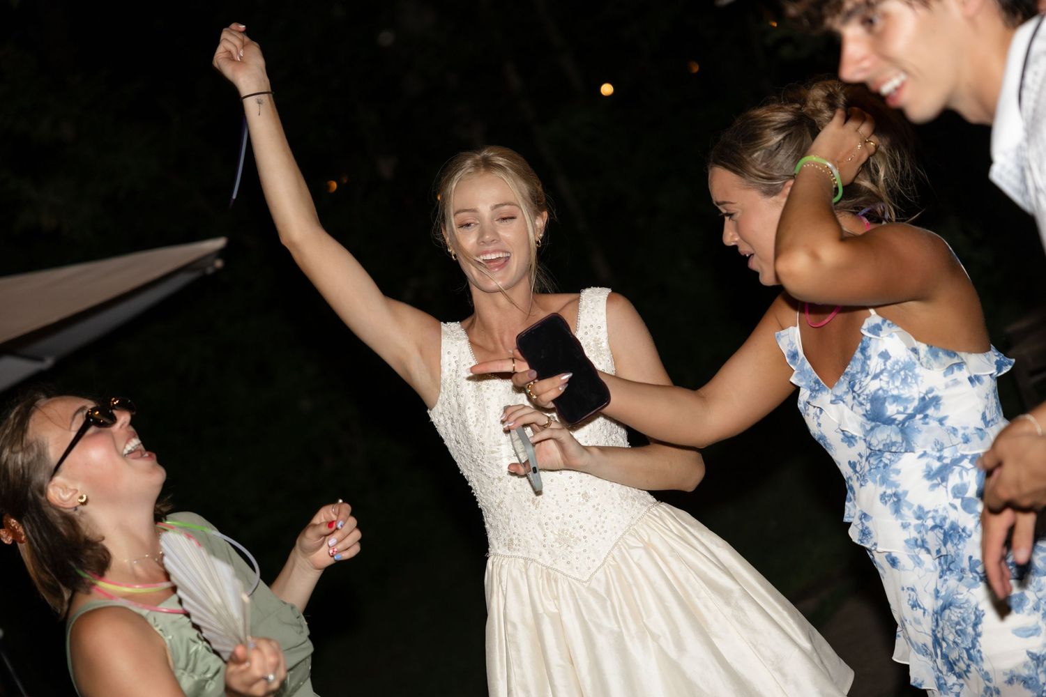 People enjoying a festive dance celebration wearing casual summer attire.