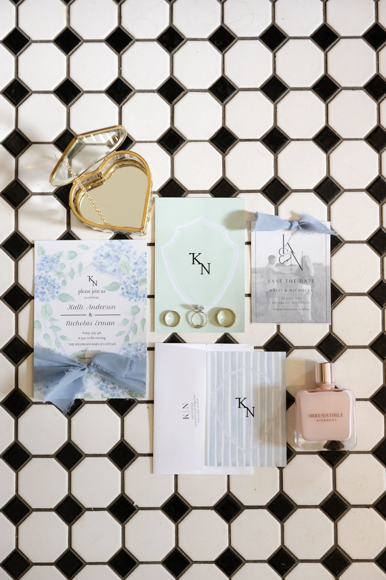 Wedding invitation suite and cards displayed on black and white octagon tile pattern.