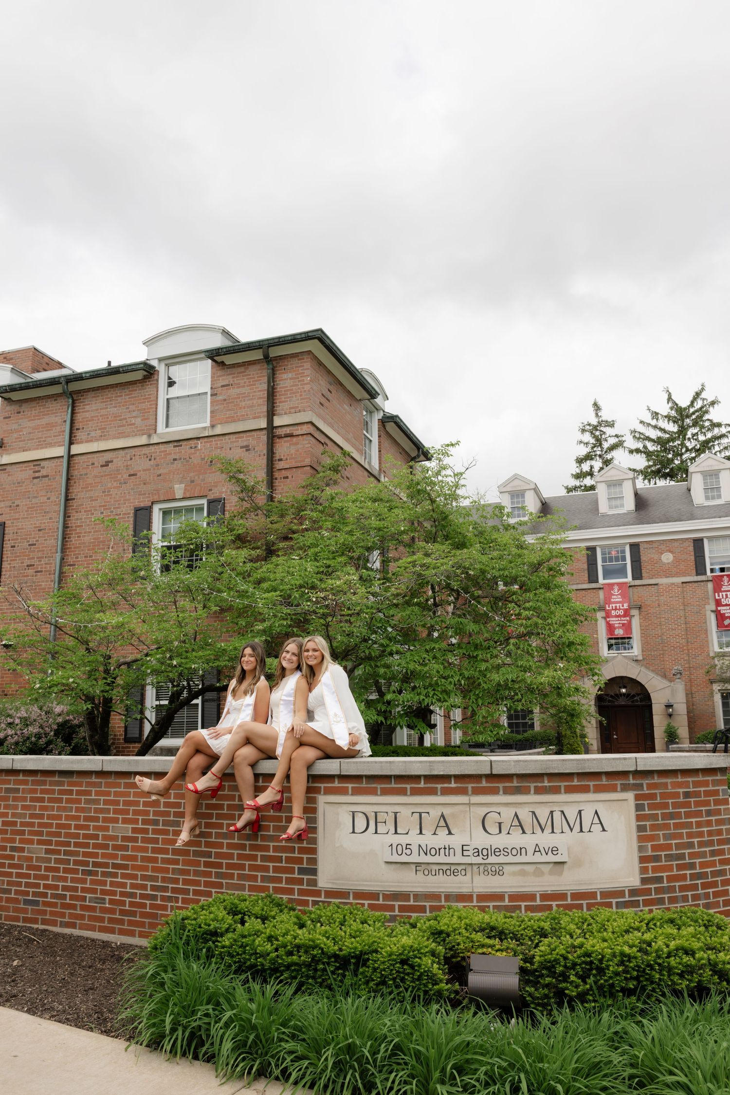 Delta Gamma sorority house entrance with brick walls and landscaped garden beds.