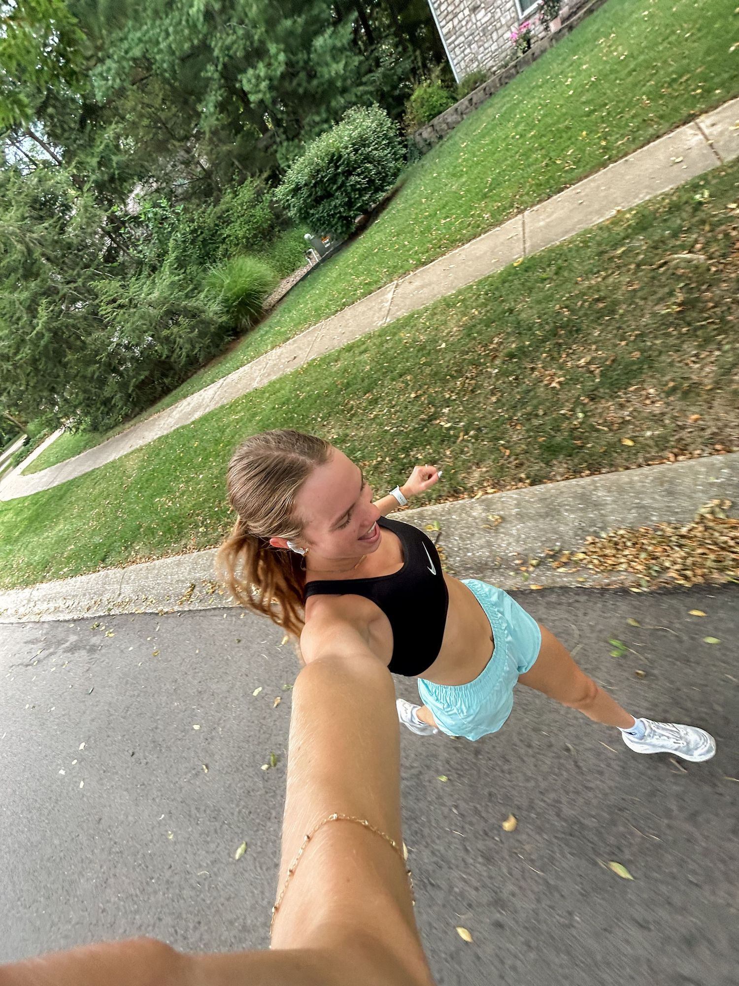 A series of stretching exercises being performed on a grassy path during outdoor workout.