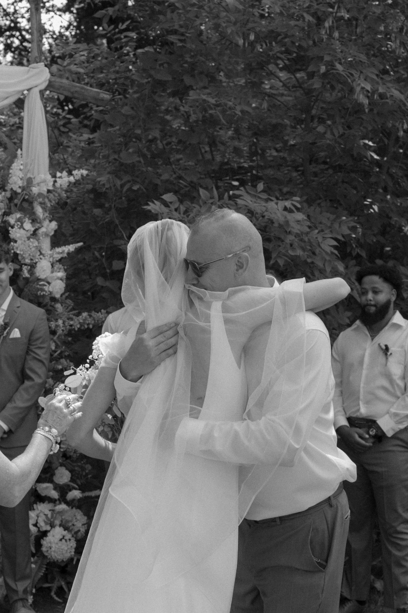 Black and white emotional moment during outdoor wedding ceremony.
