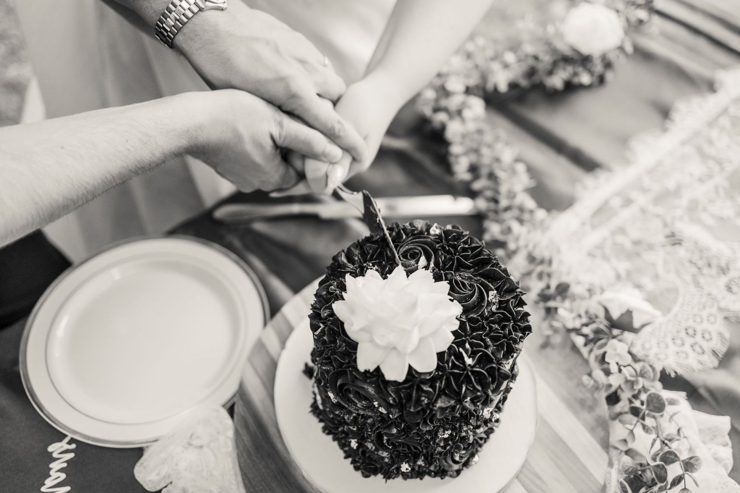 Black and white photo of decorative plates with flower designs.