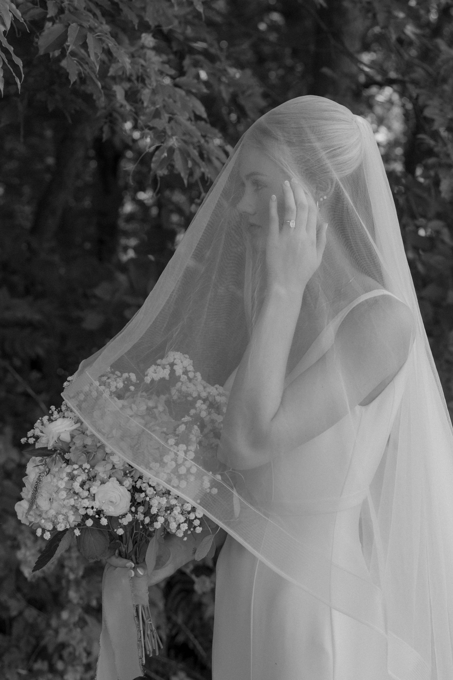 Close-up details of a delicate white bridal veil with baby's breath flowers.