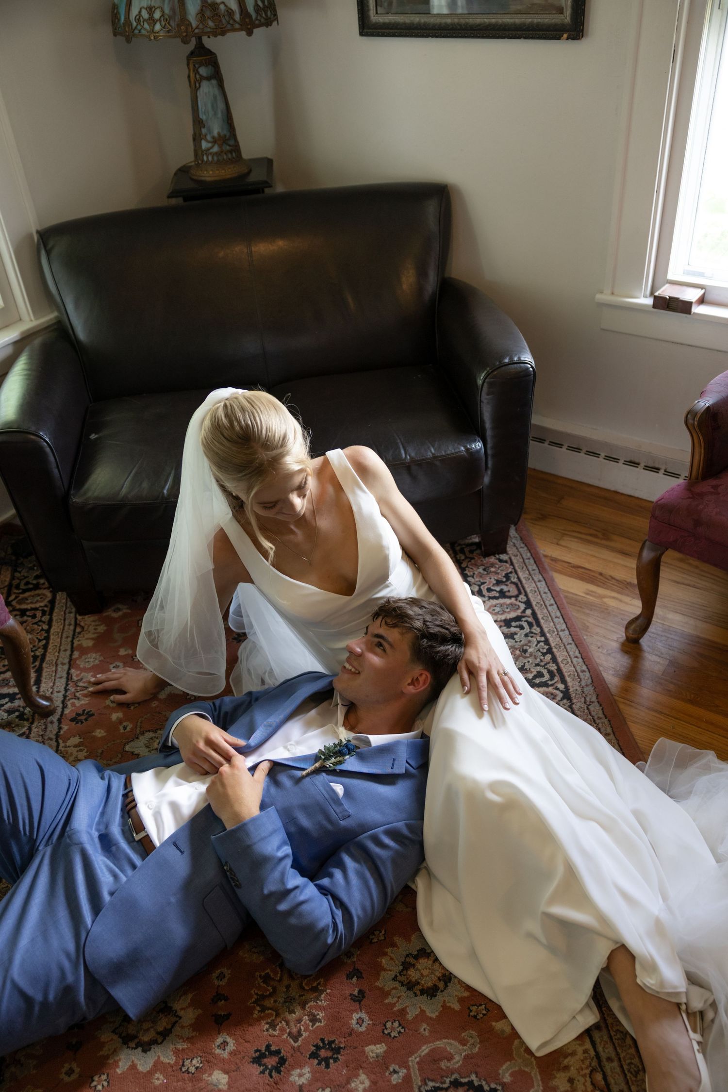 Couple sharing an intimate moment on a couch indoors in a series of candid photos.