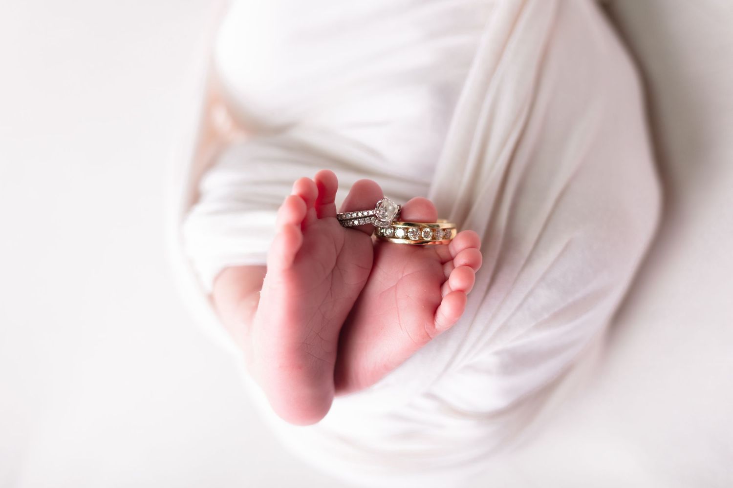 newborn with wedding rings