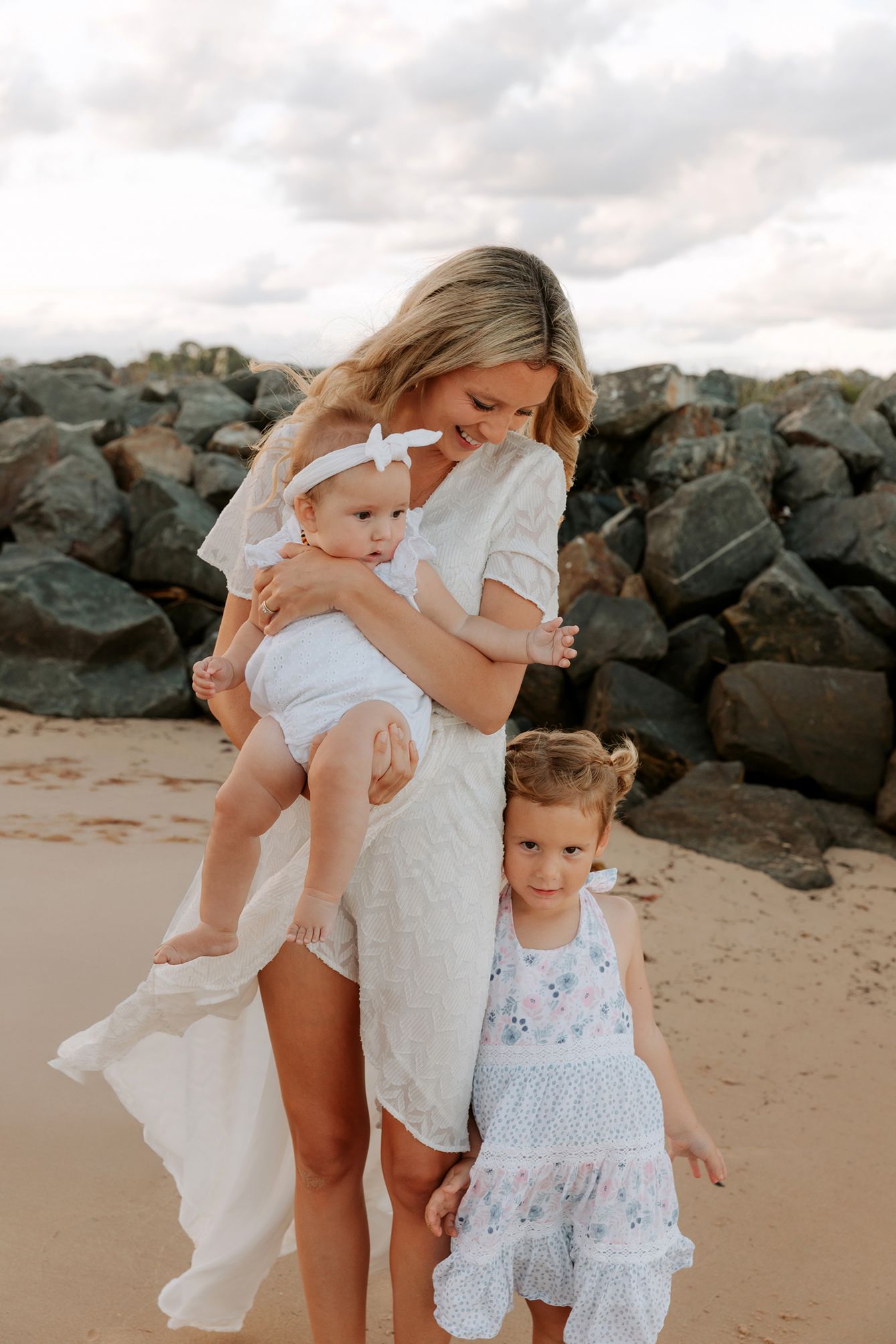 A tender moment captured on a beach during a Brisbane family photo shoot.