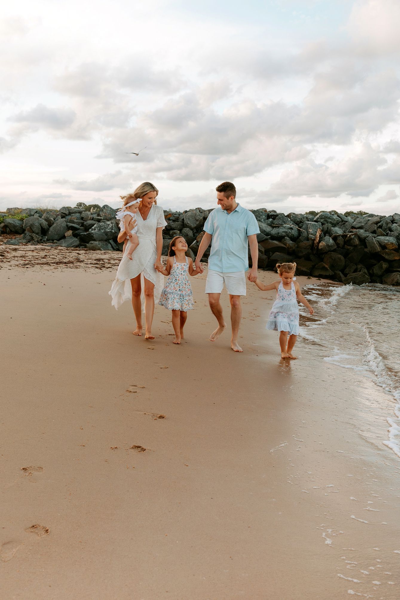 Gold Coast family photography showing playfulness and joy on shoreline.
