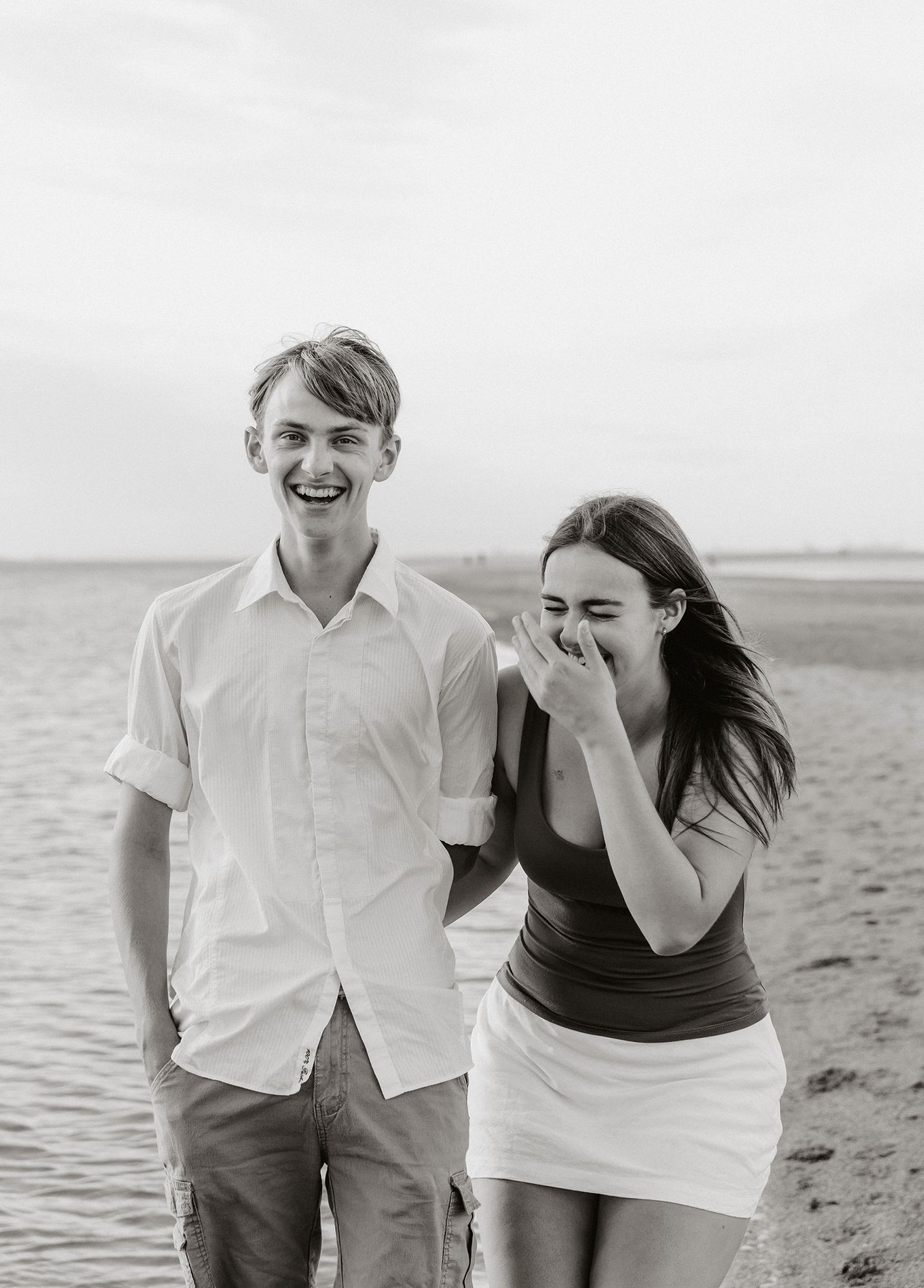 Brisbane family photography at the bayside shows siblings laughing and joking during photo shoot.