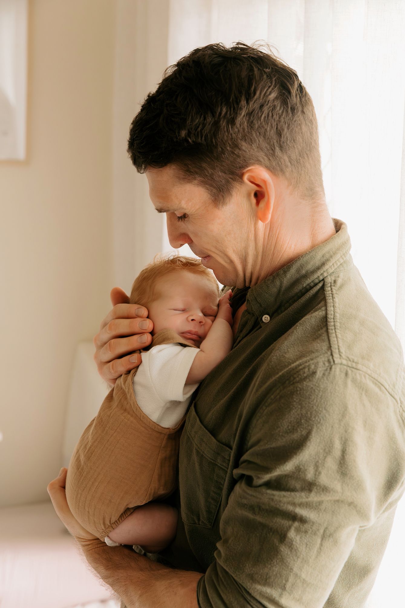 Lifestyle newborn photography at home in Brisbane, father and baby boy.