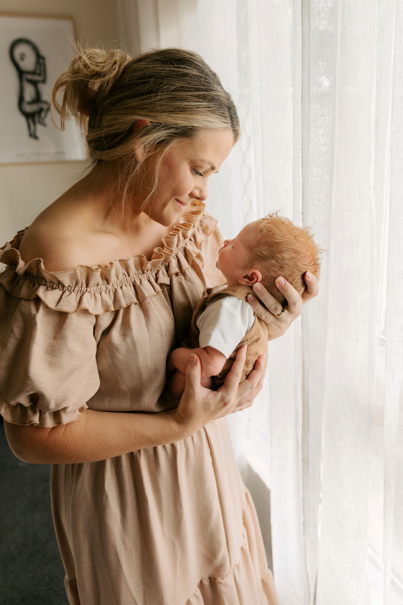 Newborn photography at home in the Redlands area, showing mother and baby boy.
