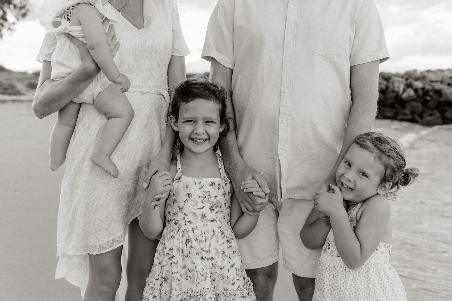 Black and white candid family portrait showing joyful expressions and natural interactions at Brisbane's bayside suburb of Raby Bay.