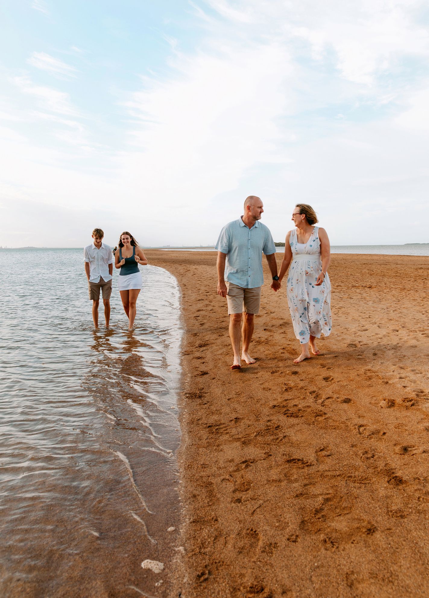 Family photography at Wellington Point beach walking and playing along shoreline during golden hour.