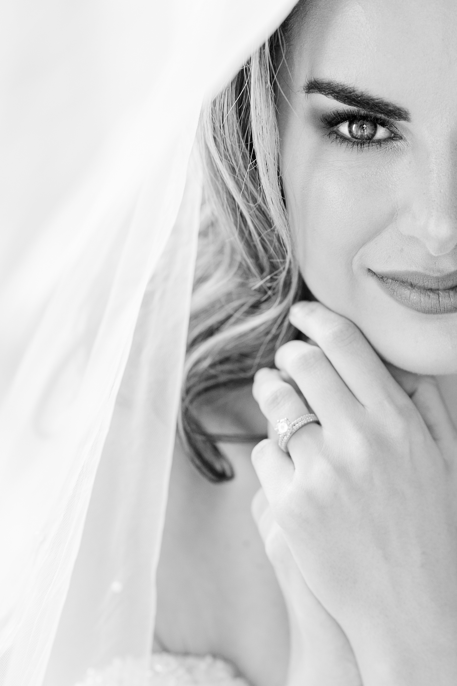 Romantic bridal portraits in black and white featuring soft veils and delicate details.