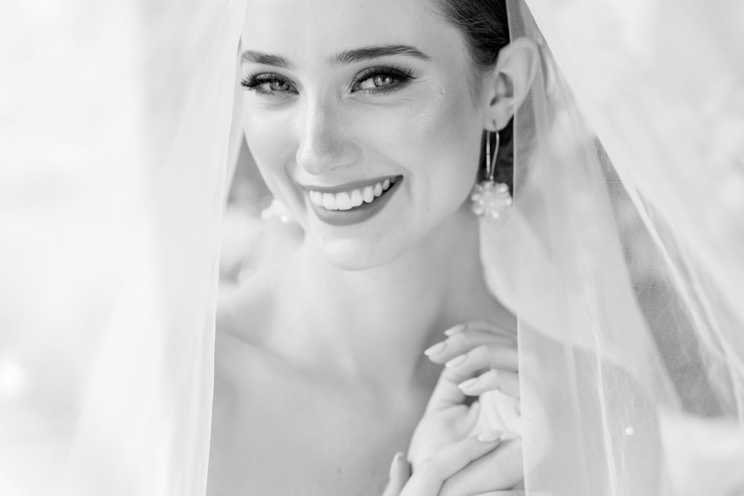 A stunning black and white wedding photo collage showing joyful moments and details of a bride in her veil.