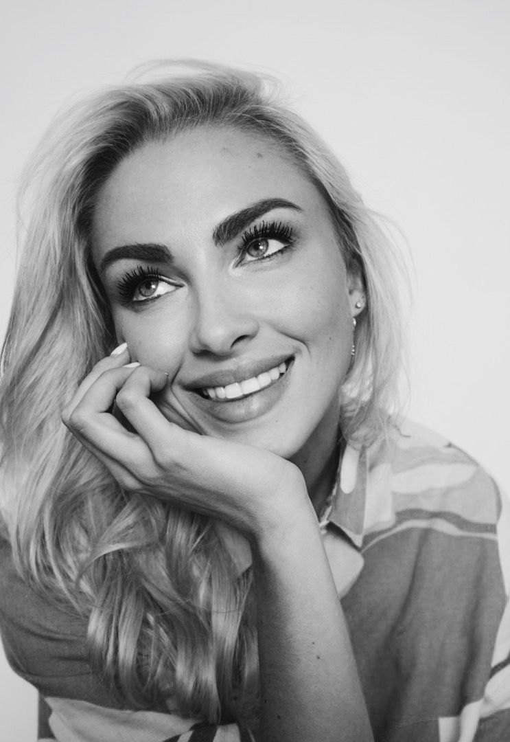 Black and white portrait series showing expressive poses and joyful smiles in a minimalist style.