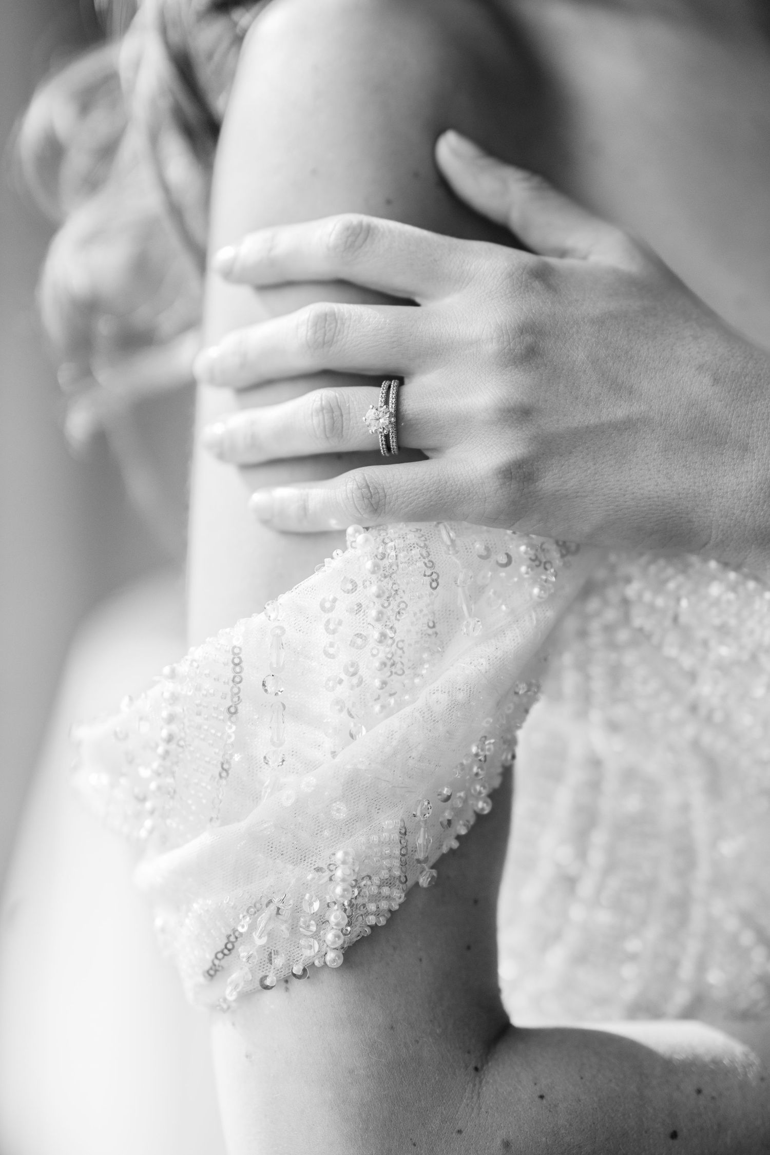 A sequence of black and white cropped photos showing a hand wearing rings adorned with delicate beaded lace details.