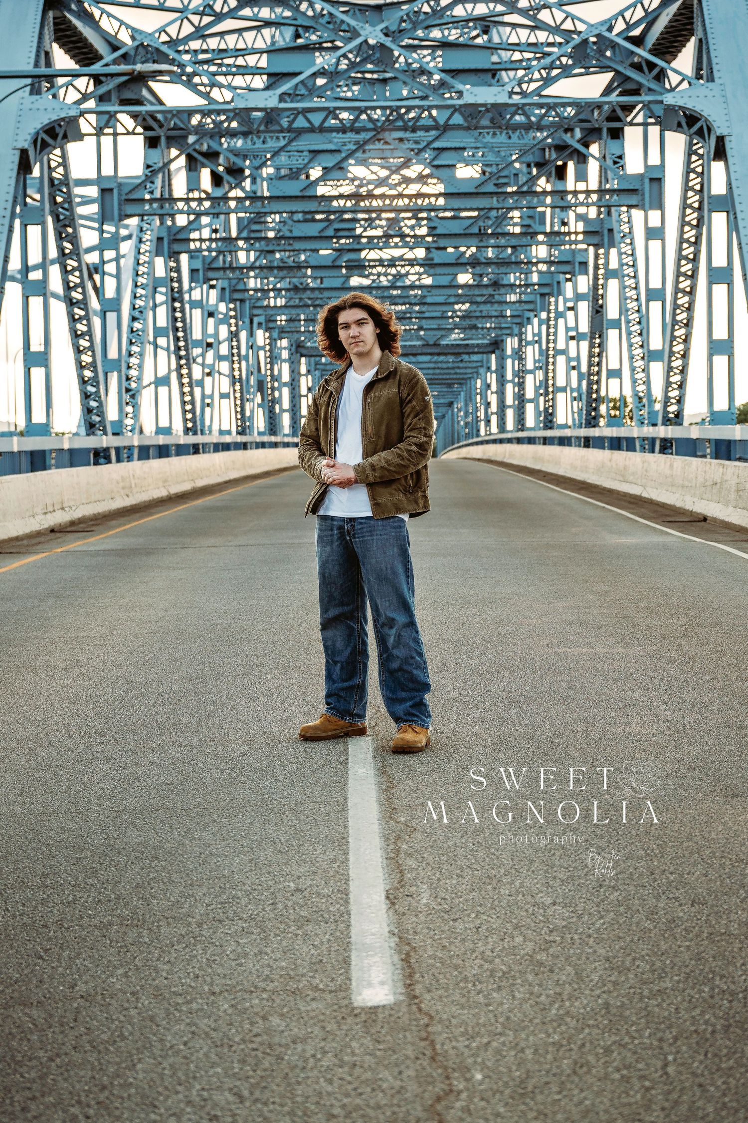 Industrial bridge photography session with steel beams and geometric patterns.