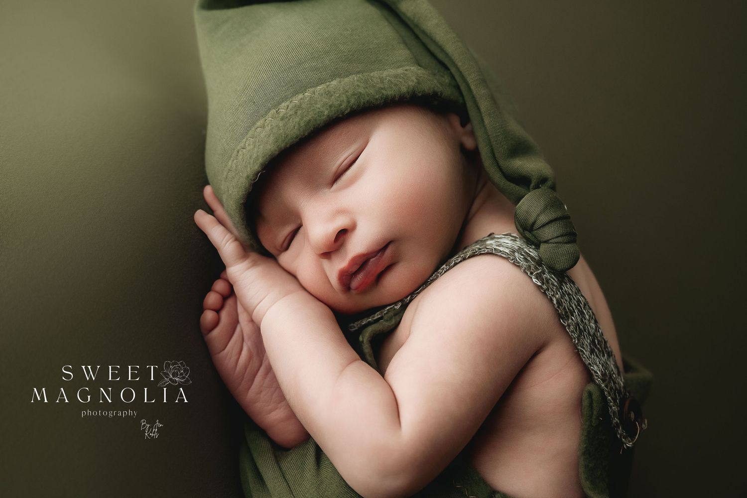 Cozy newborn portraits in olive green tones with soft natural lighting.