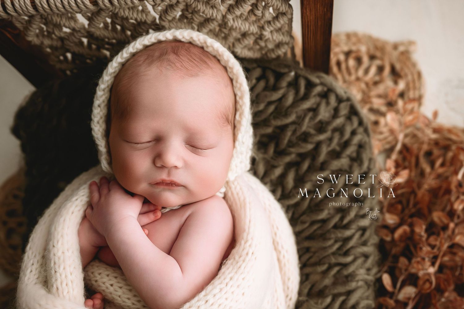 Professional newborn portraits with textured blankets and soft lighting.