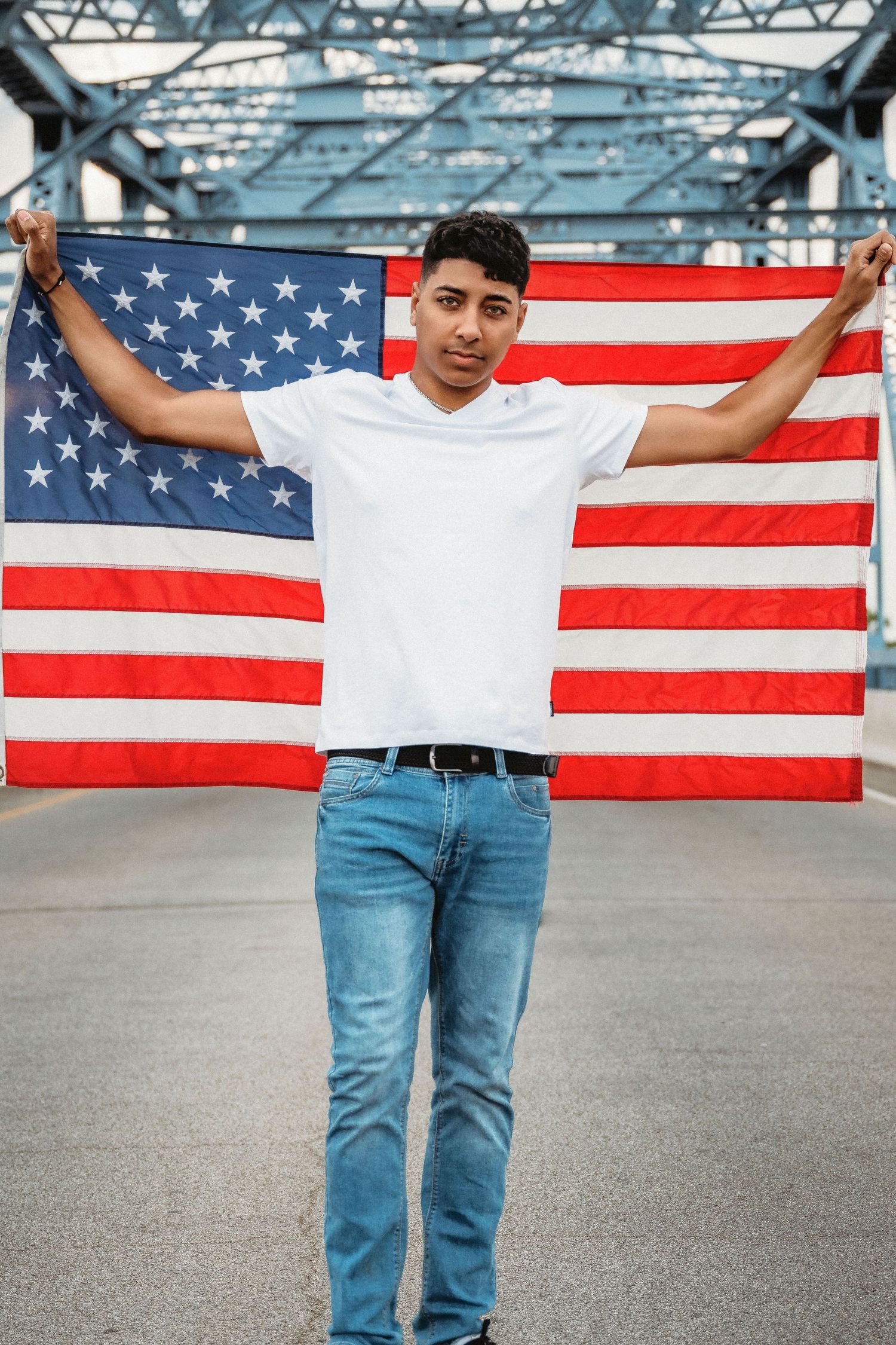 American flag backdrop portrait on bridge with patriotic theme.