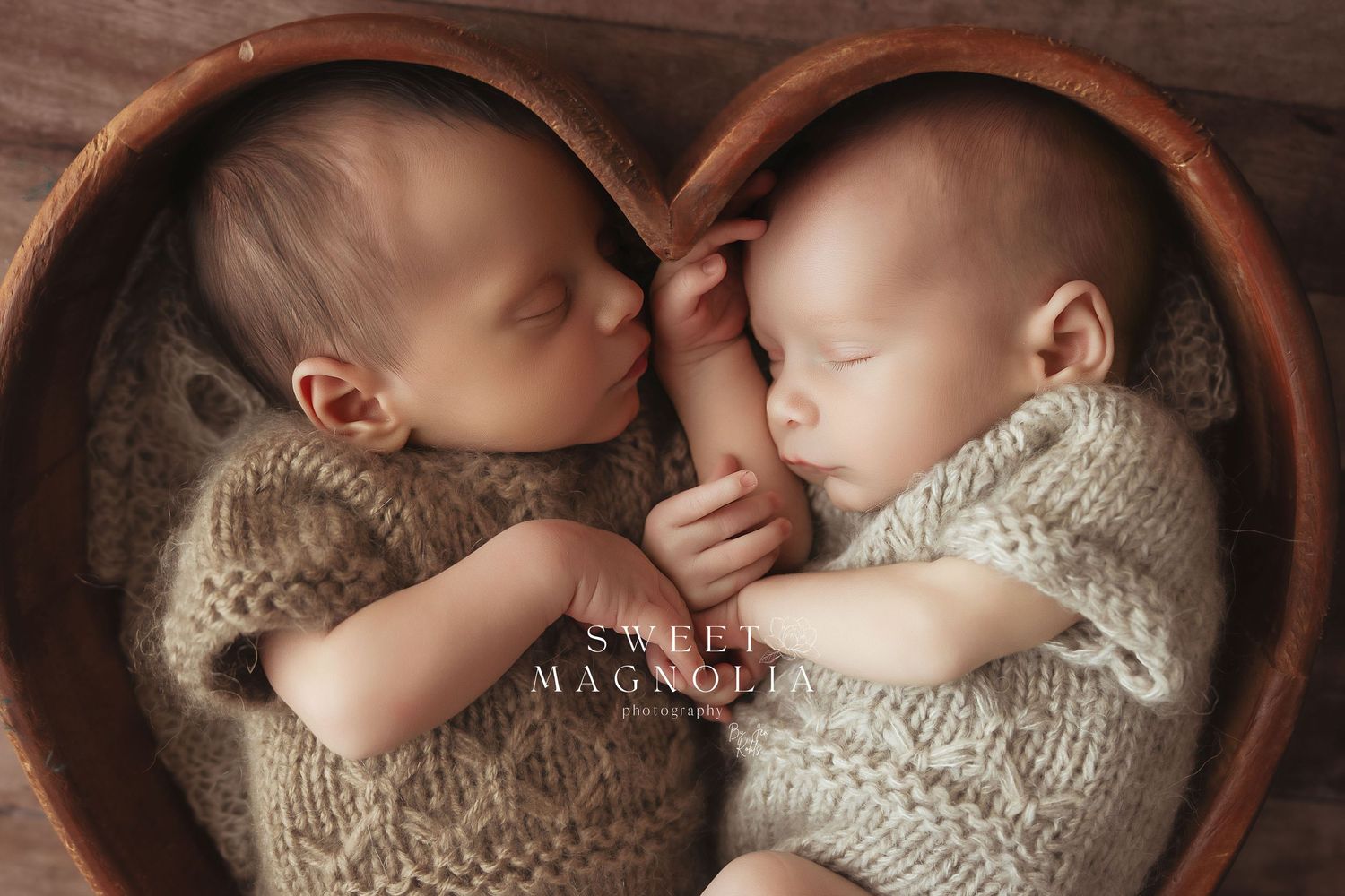 Sleeping infant nestled in a rustic wooden bowl with cozy knit clothing.