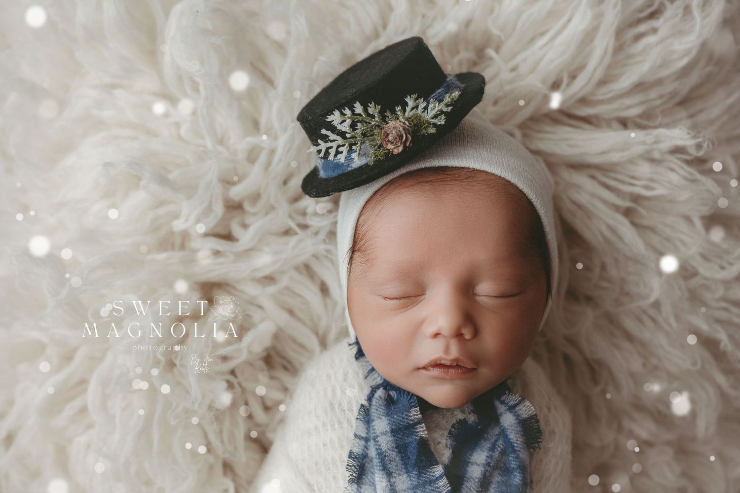 Ethereal newborn portrait with soft white textures and delicate headpiece.