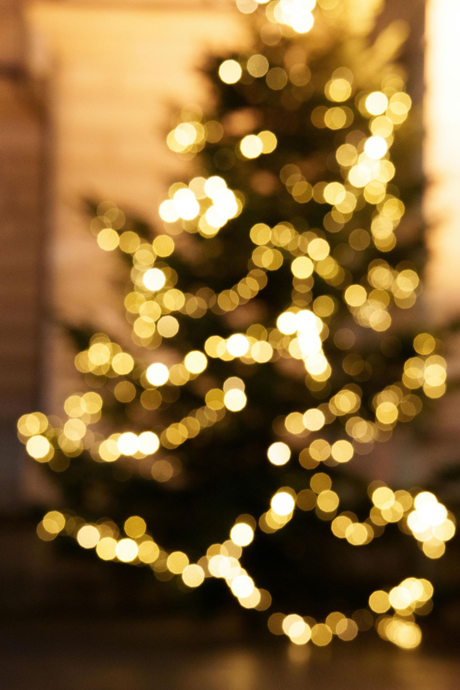 Bokeh lights from Christmas tree decorations creating a golden glow.