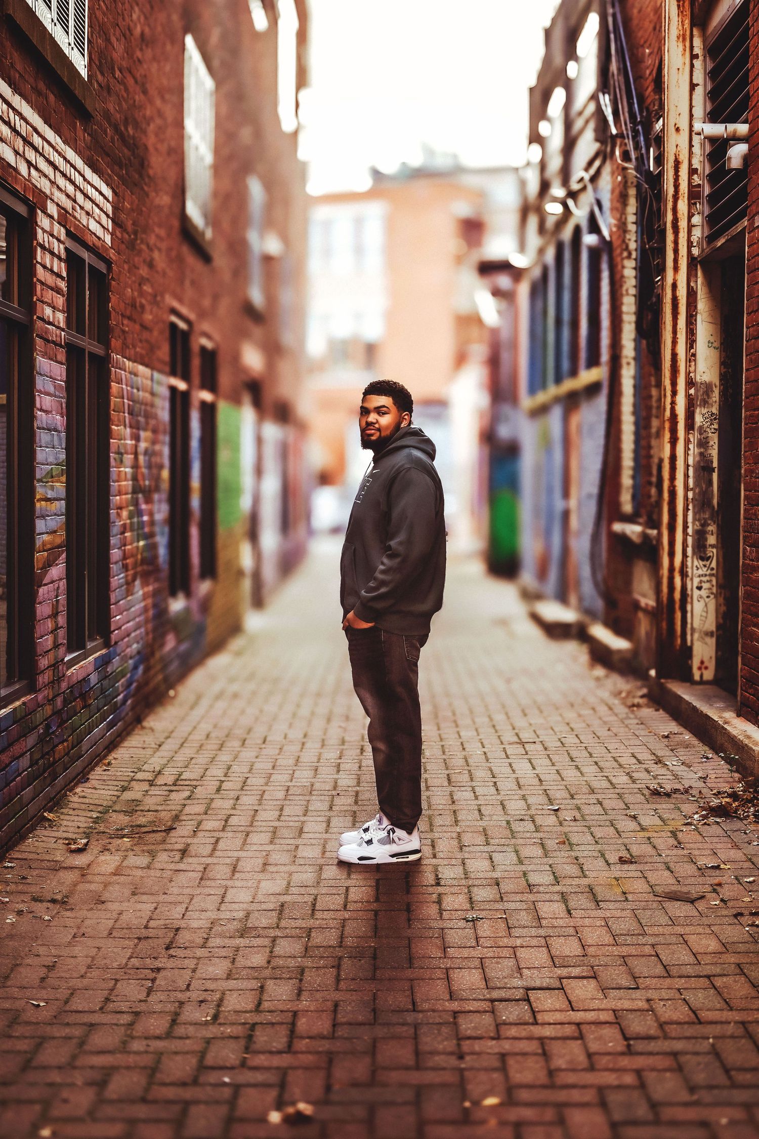 Person walking through brick alley in urban setting captured in multiple frames.