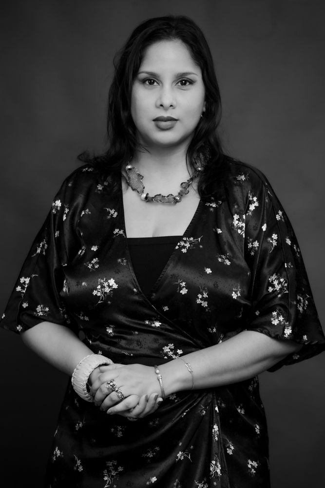 A series of black and white portraits showing a person in a floral dress against a dark background.