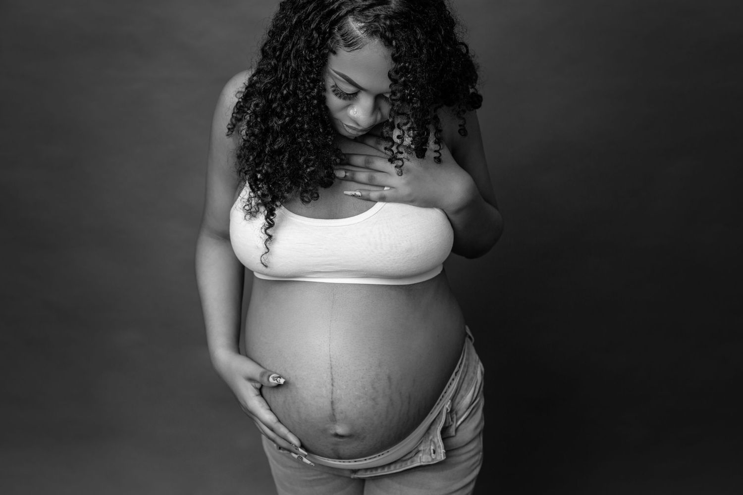 Artistic black and white maternity photo showing a tender moment.