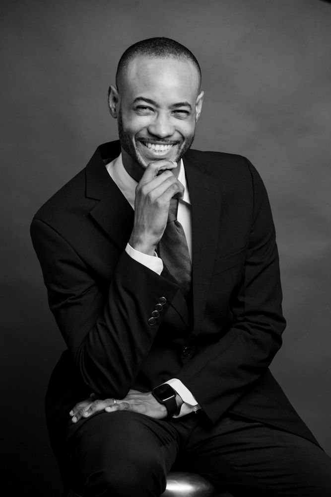 A series of black and white professional portraits showing joyful expressions and laughter while wearing a dark suit.