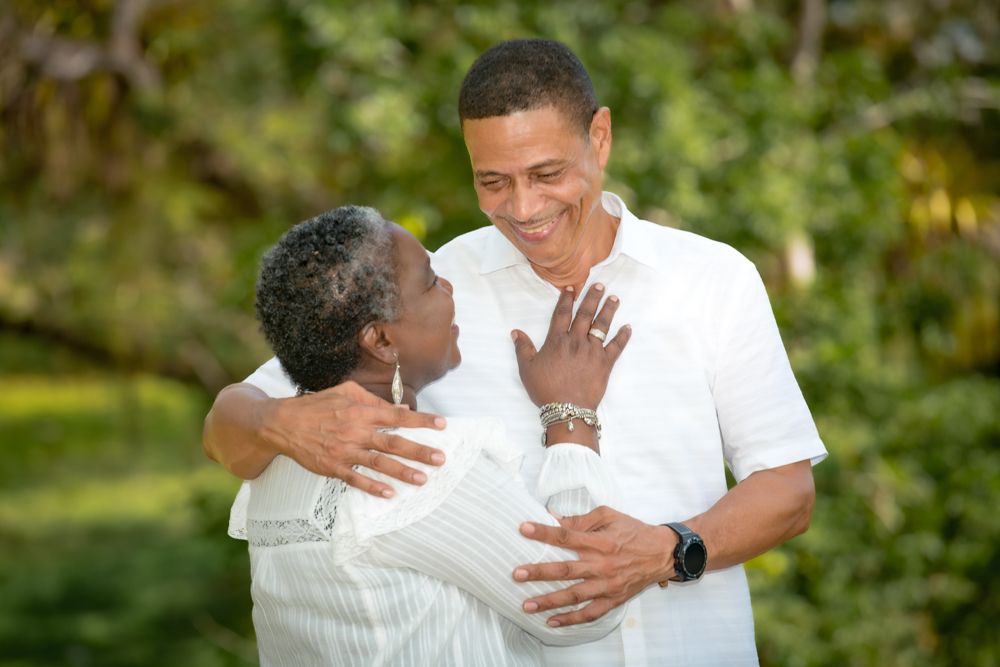 A series of outdoor photos showing a couple embracing and laughing together in a natural garden setting.