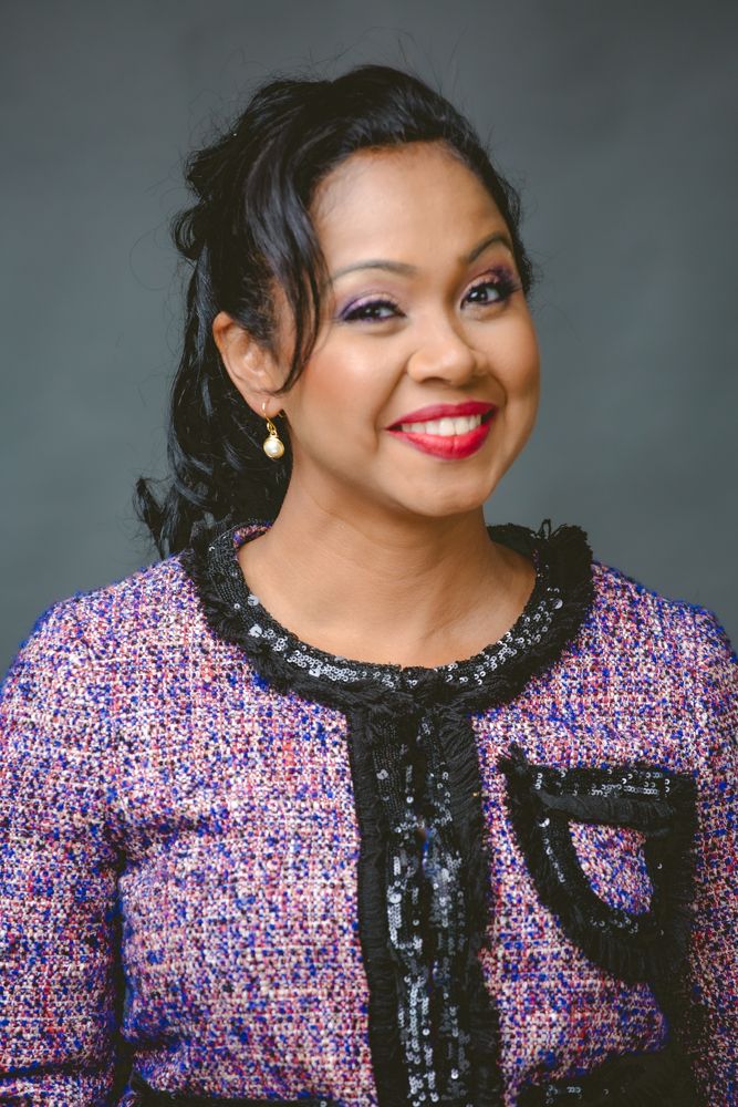 A series of five headshots showing a person wearing a sparkly purple and pink tweed jacket with black lace trim.