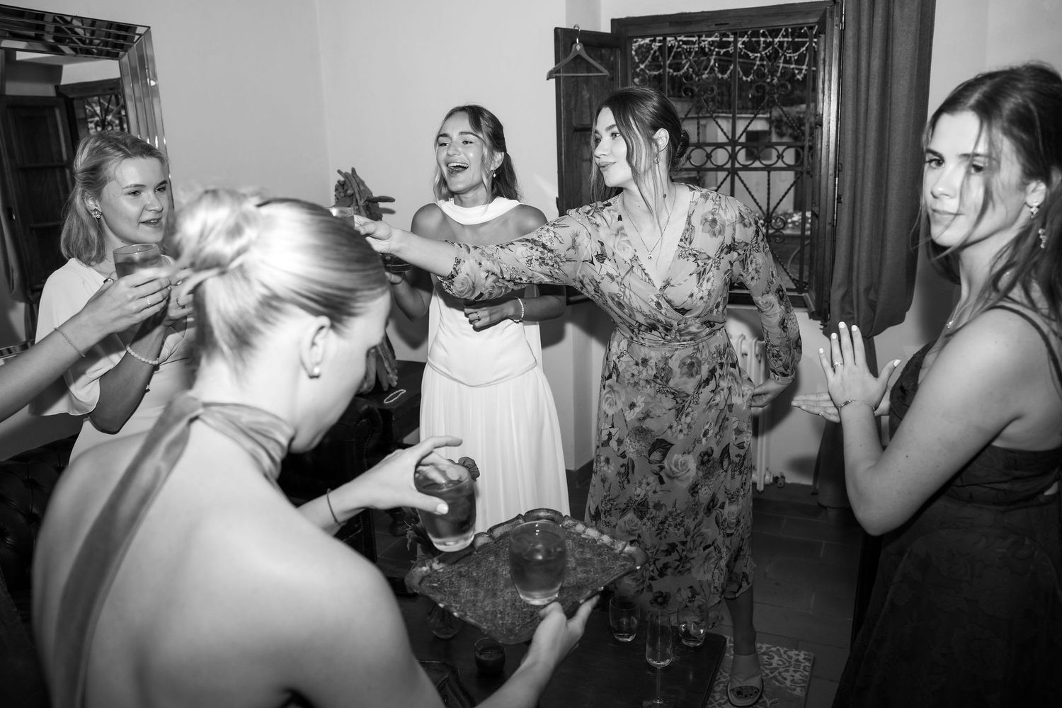 A series of black and white photos showing people taking shots of alcohol at what appears to be a party or celebration.