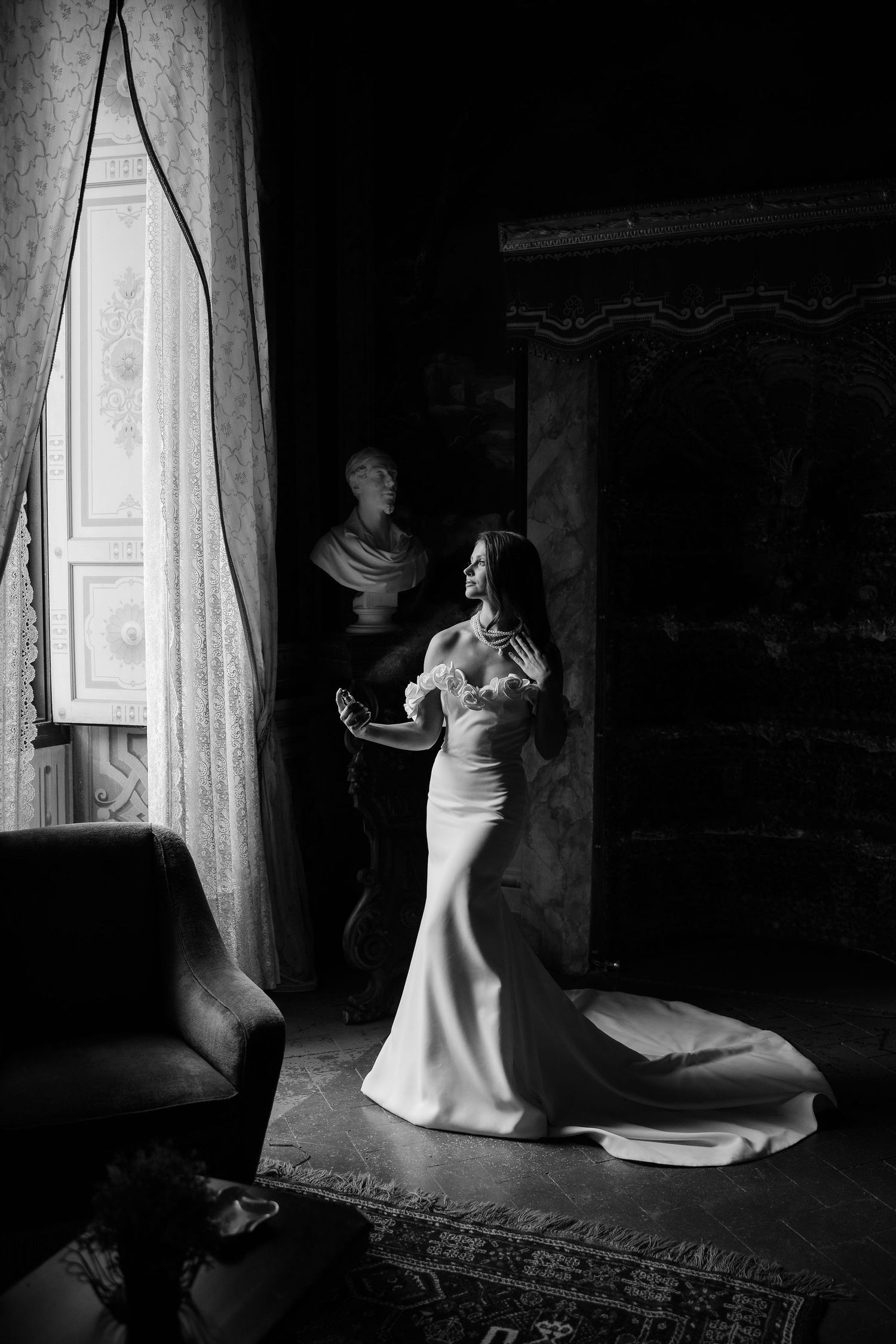 A dramatic black and white photo sequence shows a figure moving near a window in a dark room with flowing white fabric.