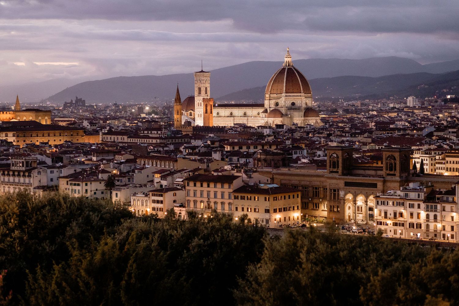 Dramatic sunset view of Florence skyline with iconic Duomo cathedral dome and historic architecture in Italy.
