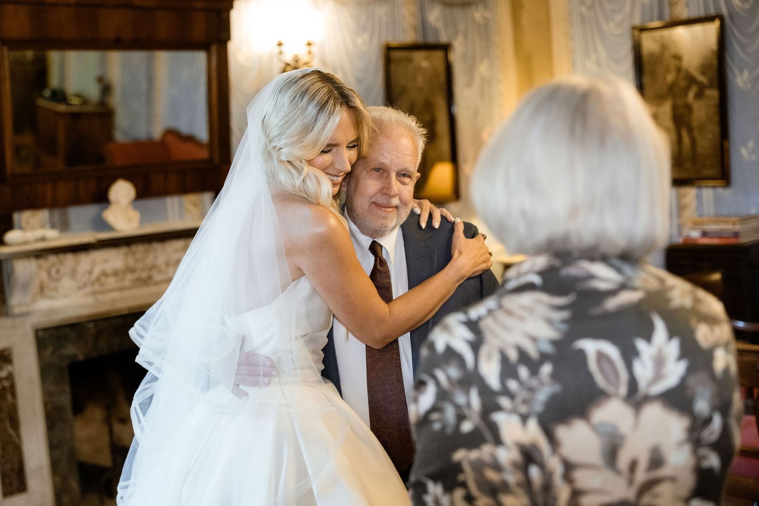 Bride and groom share an intimate dance during their wedding reception in a rustic venue.