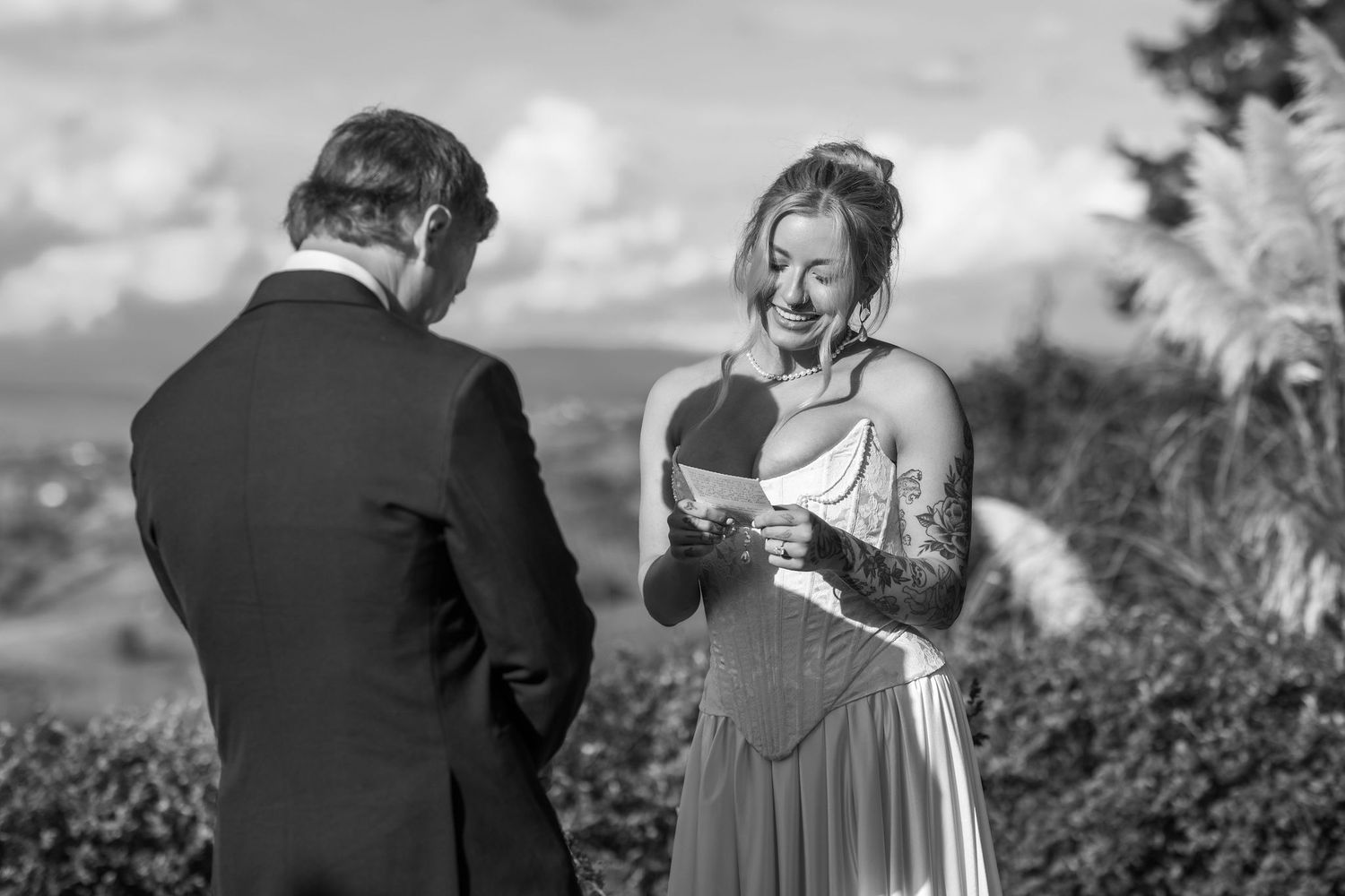 A couple shares a tender moment during their wedding photo session in a scenic outdoor setting.