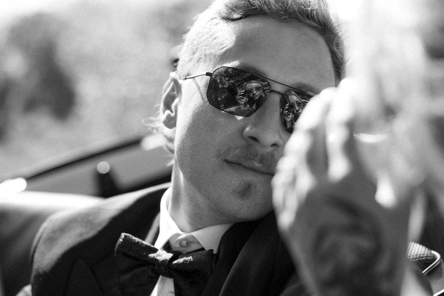 A series of black and white headshots arranged in a horizontal row showing people wearing sunglasses.