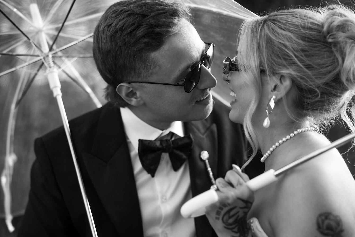 Black and white collage of romantic wedding kisses with sparklers creating a magical nighttime atmosphere.