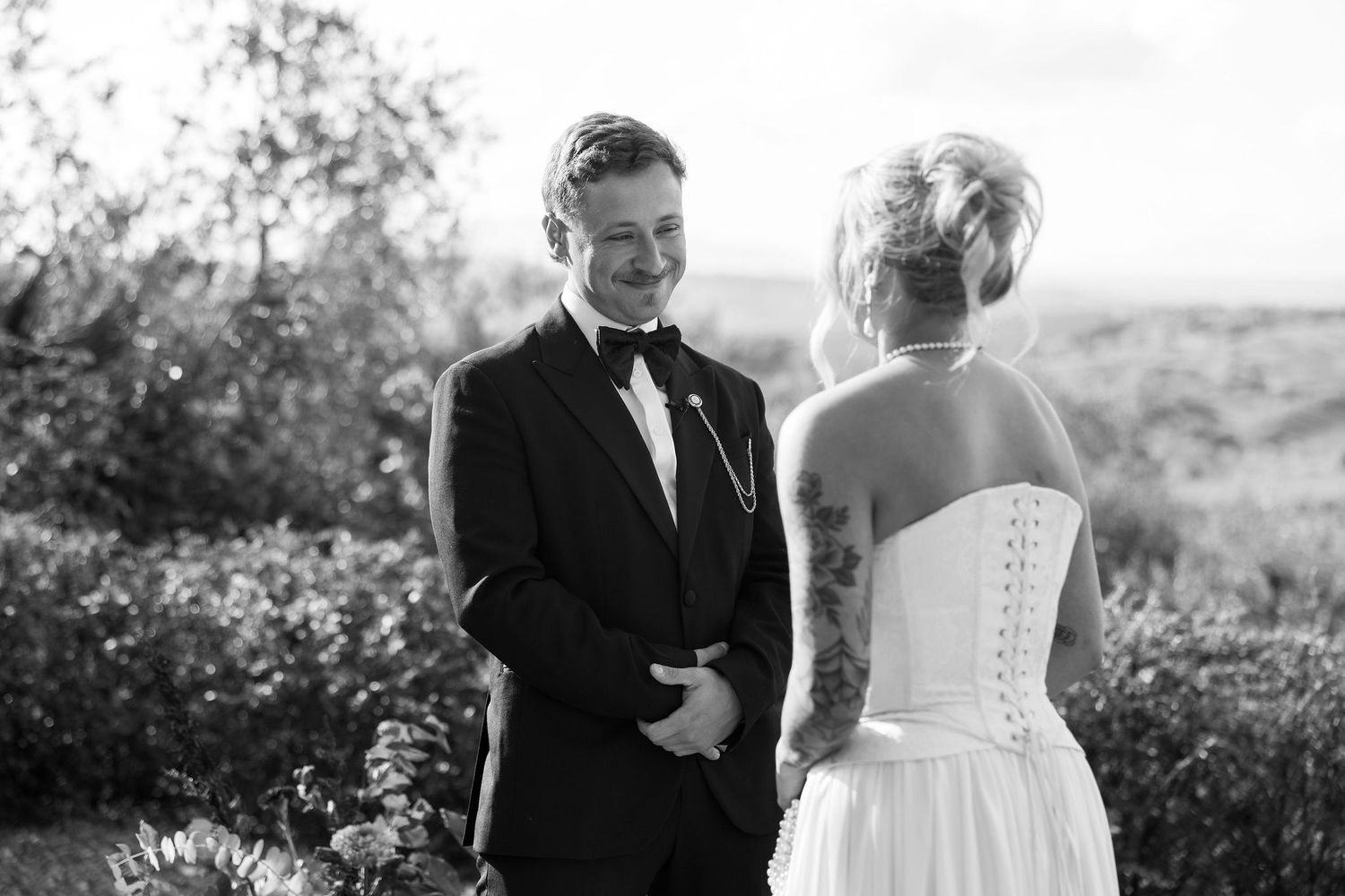 Black and white wedding photo collage showing intimate moments between newlyweds in an outdoor garden setting.
