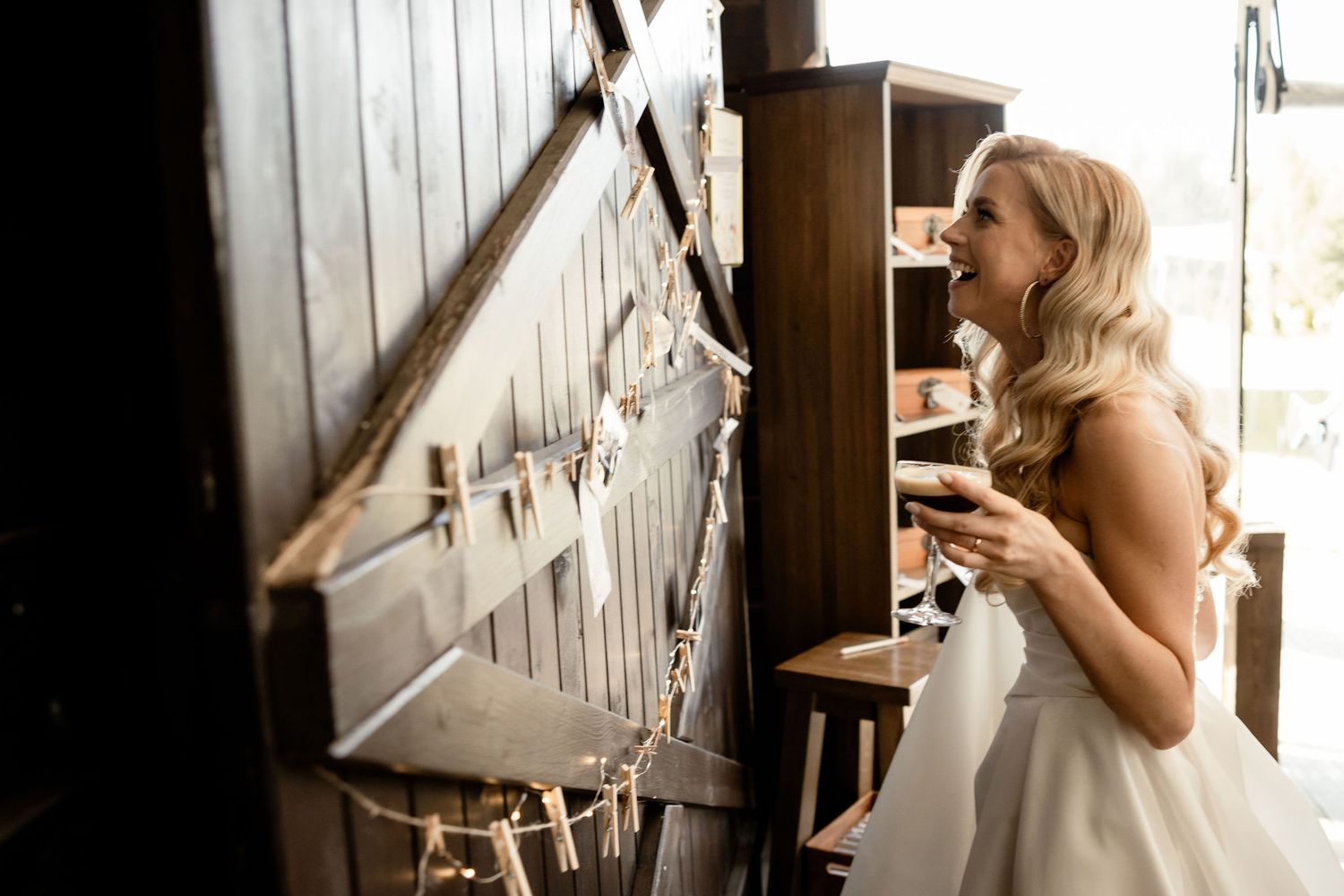 A wedding dress detail shot against rustic wooden barn doors.