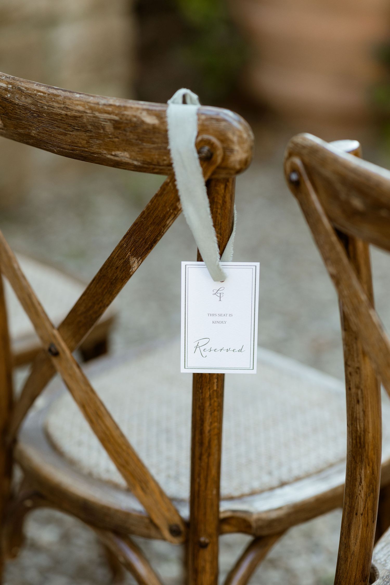 Wooden antlers mounted on a wall with small white tags or labels attached to the tips of the branches.