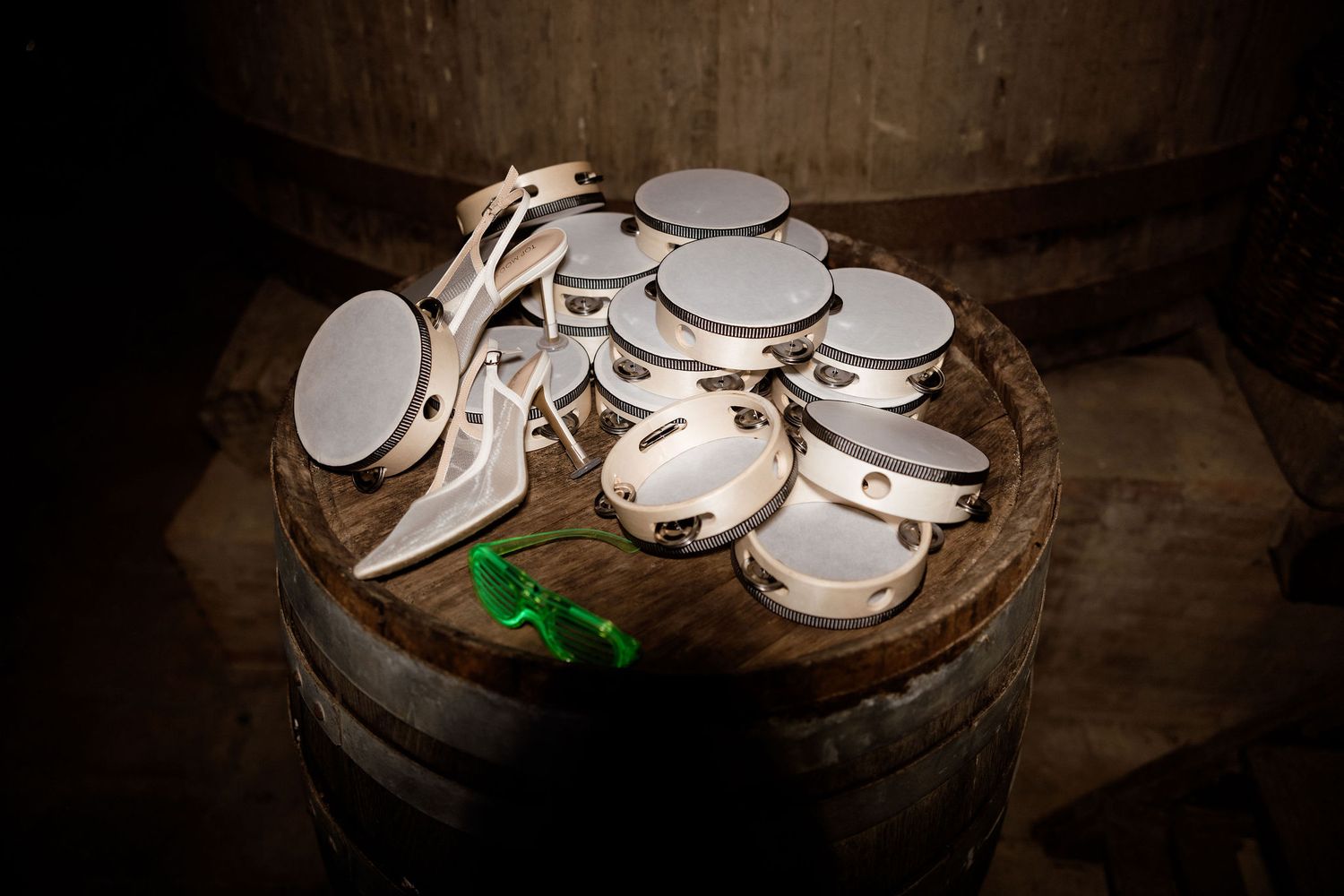 A sequence of seven dark moody photographs showing white mushrooms growing in rich soil with dramatic lighting.
