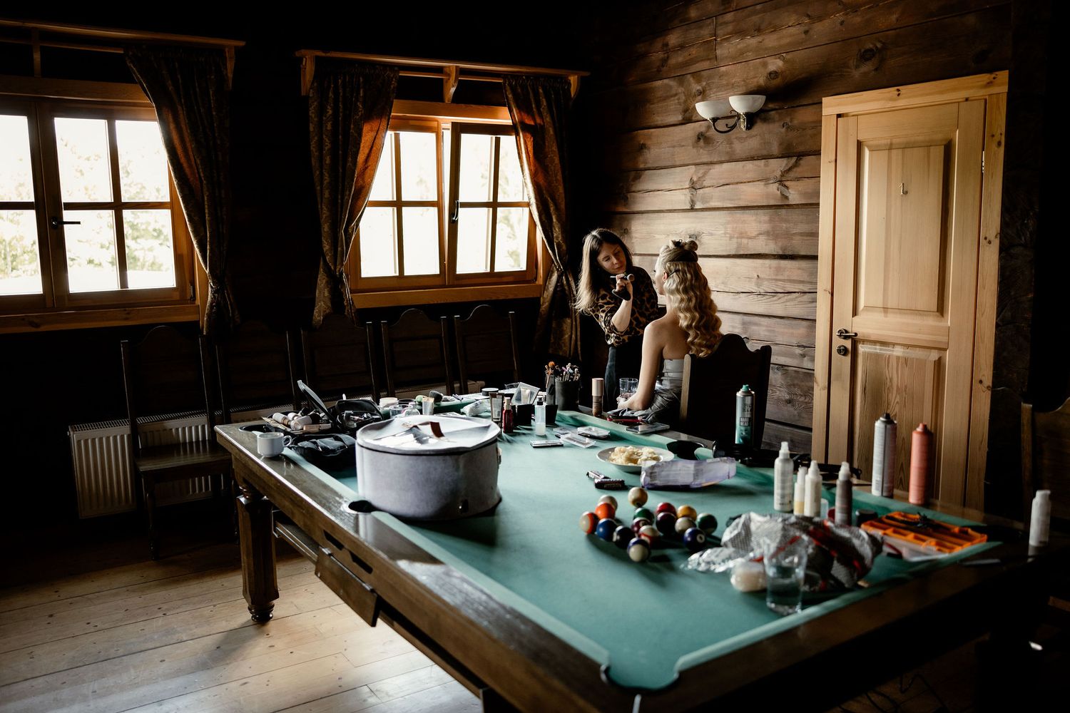 Interior of rustic cabin with table setup showing wedding day preparations.