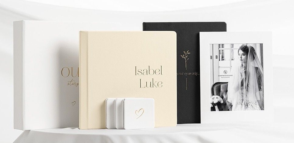 A row of minimalist white and beige book spines arranged on a shelf showcasing elegant editorial design.